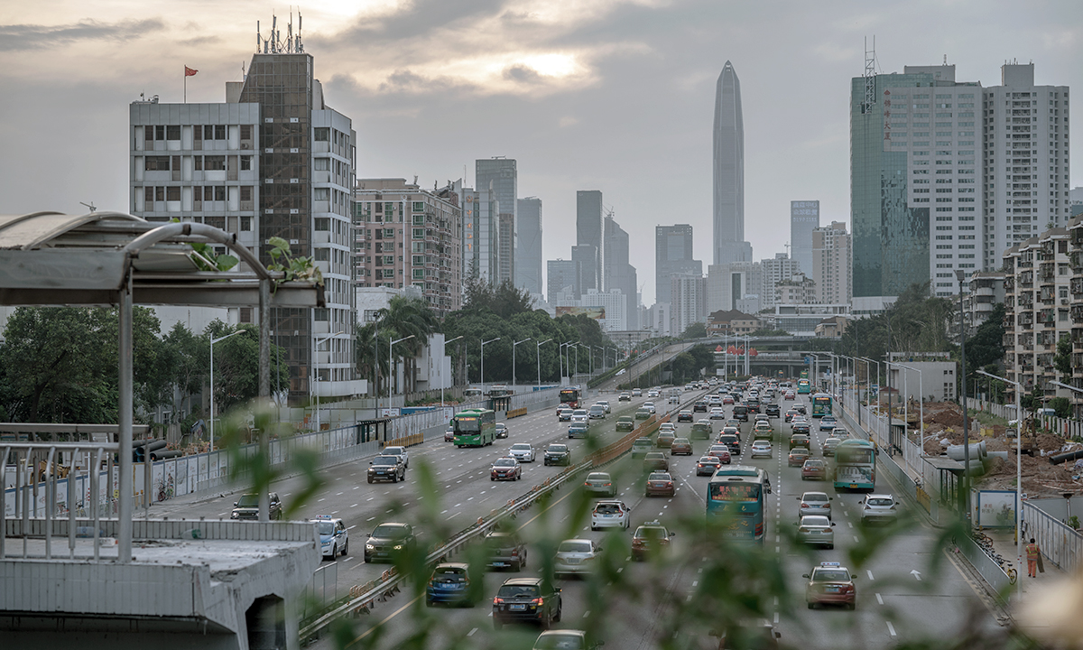 A busy artery feeds traffic into Shenzhen, where the government has converted bus and taxi fleets to electric vehicles. 