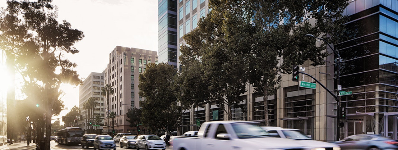 Downtown San Jose at rush hour with sunset and moving traffic