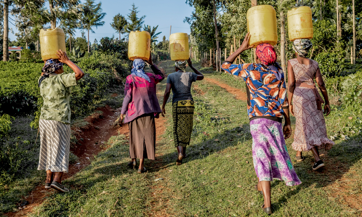 Women carrying water jugs