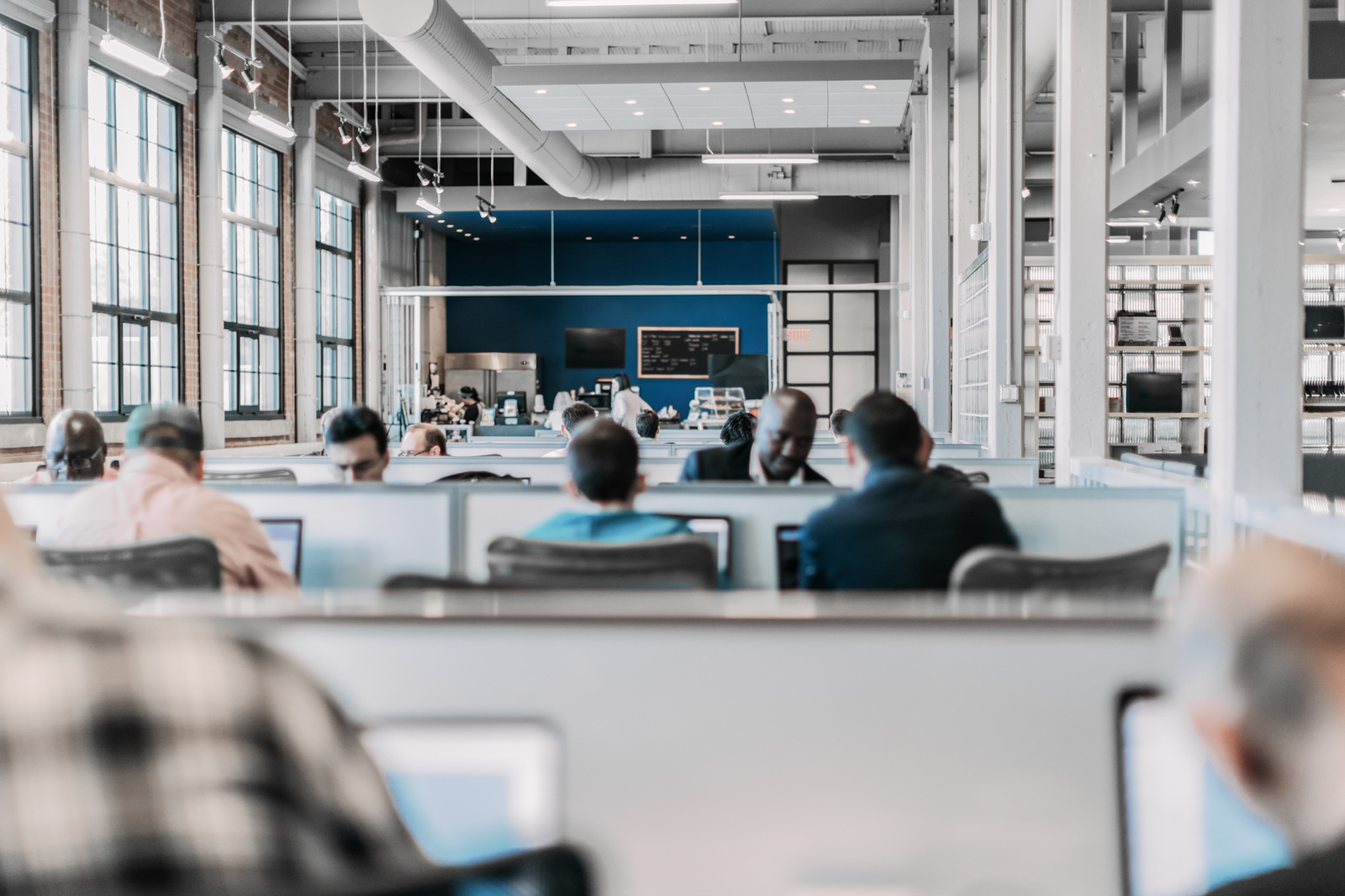 Group of people working in an open plan business. Startup. Bring your own device area.