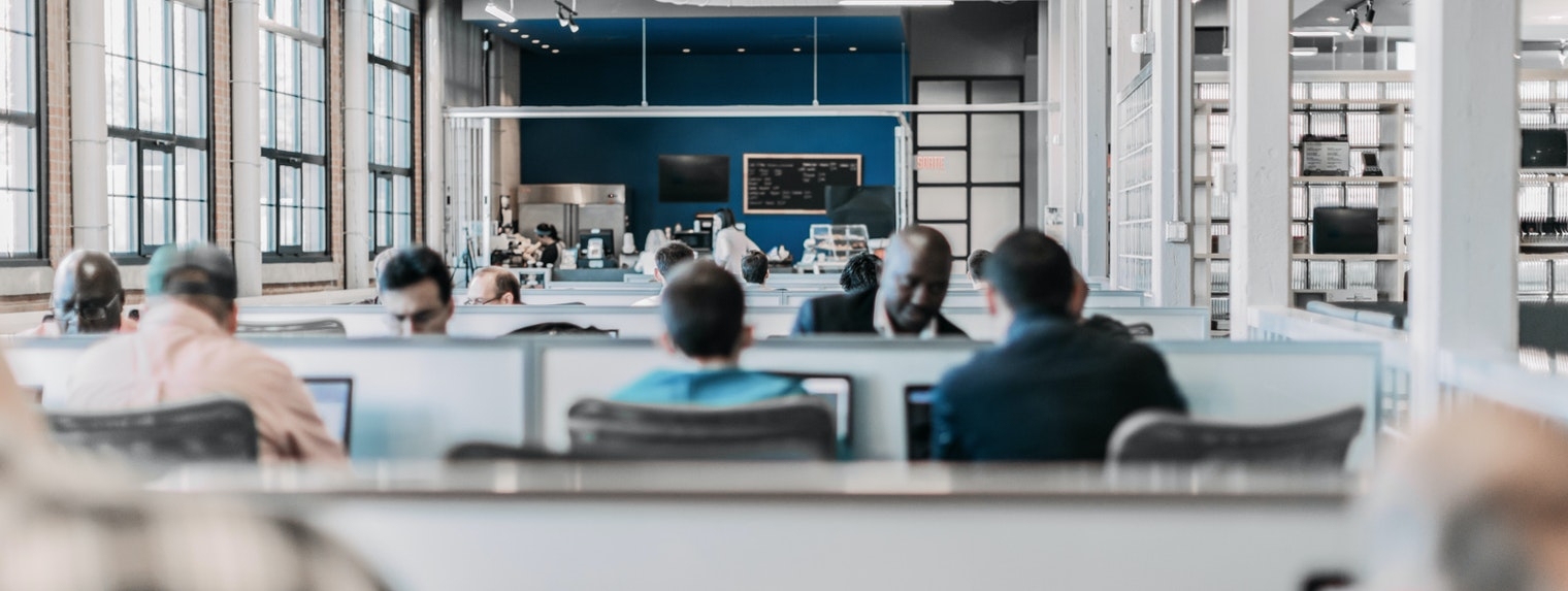 Group of people working in an open plan business. Startup. Bring your own device area.