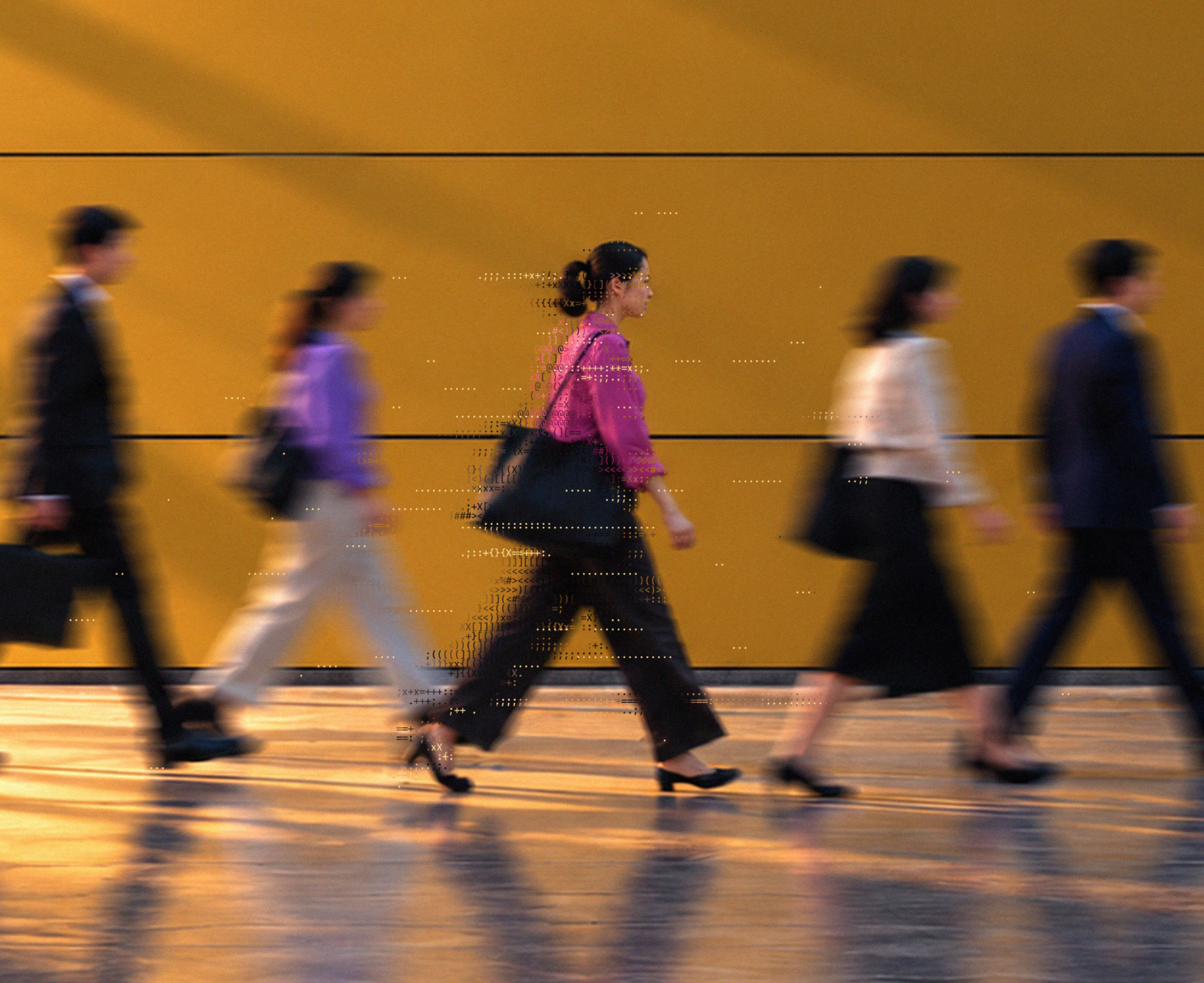 People walking past a warm orange architectural wall