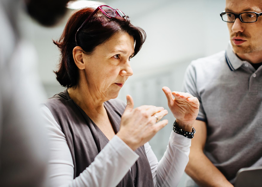 Woman works with business colleagues.