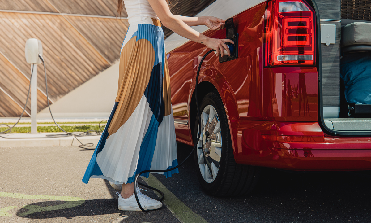 A driver charging an electric vehicle.