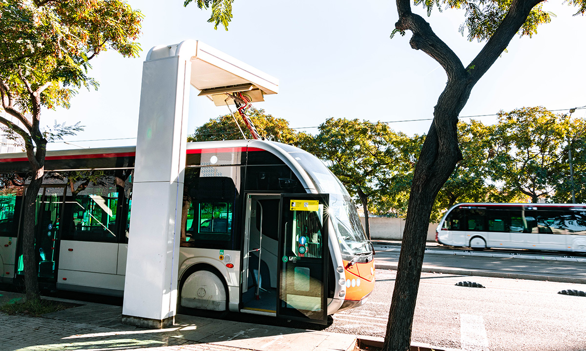 An electric bus arrives at a station.
