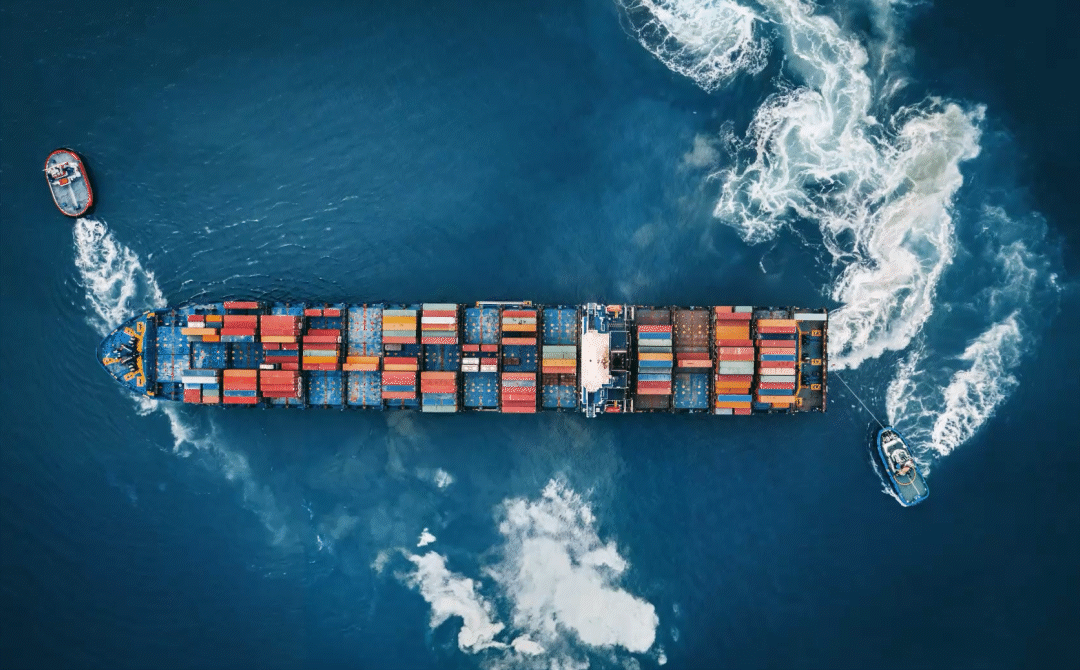 Aerial view of a container ship with AI data overlays illustrating the industrial AI divide in transportation, logistics, and defense.
